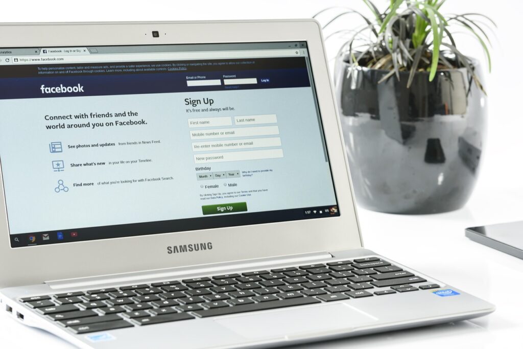 Laptop screen showing Facebook login in an office